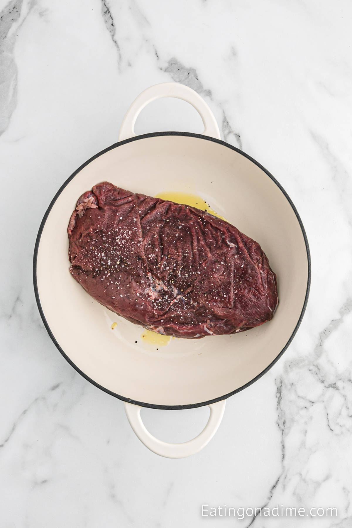 Uncooked venison roast in a large pot