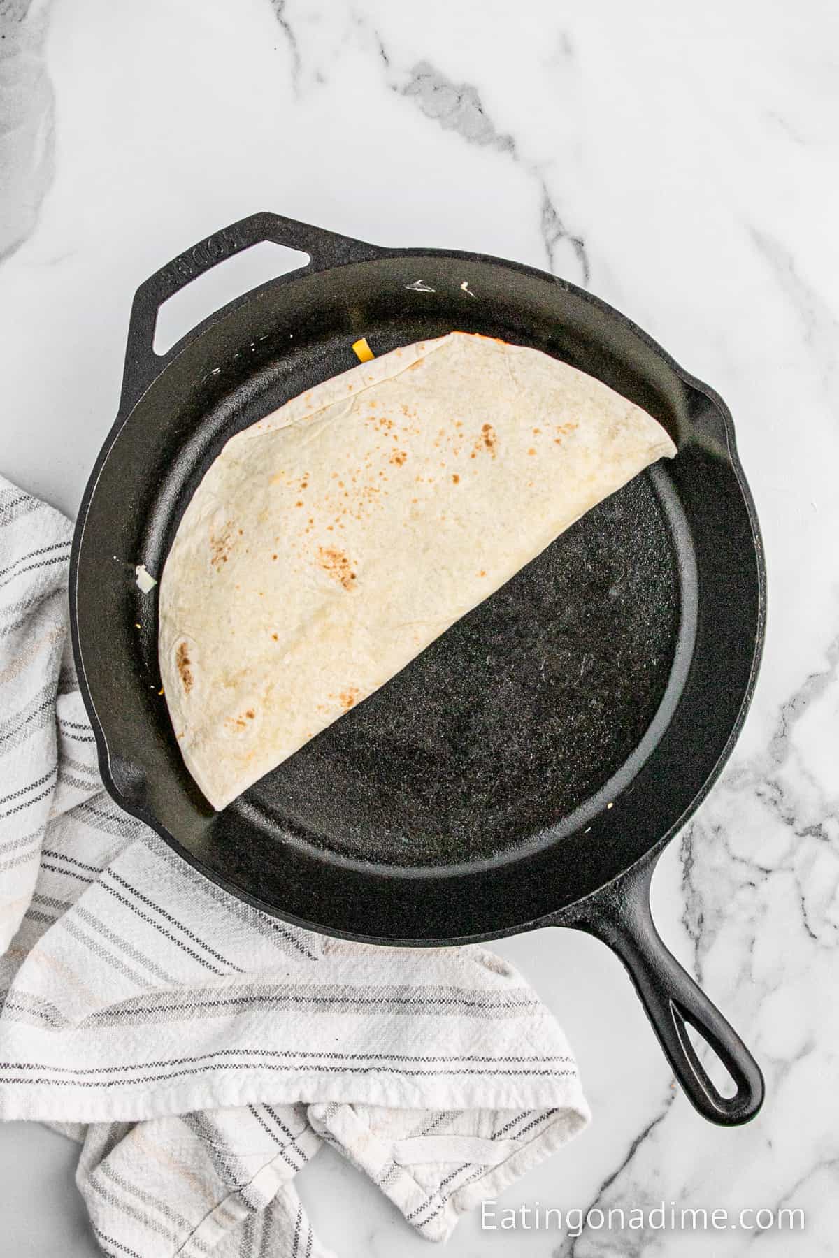 Folded tortilla in a cast iron skillet