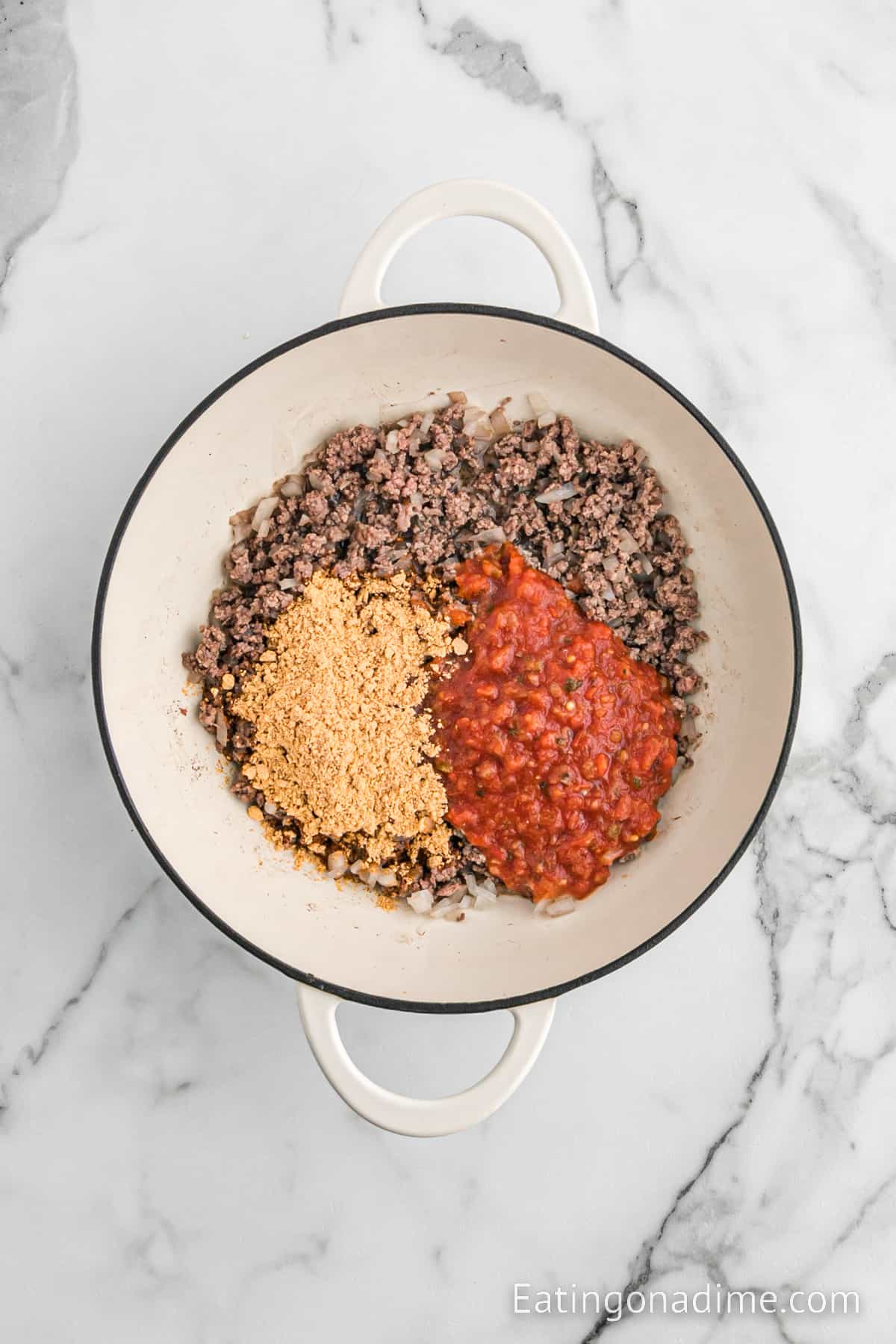 Cooked ground beef topped with taco seasoning and salsa