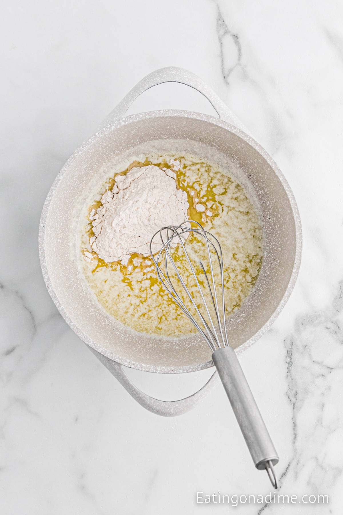 Melted butter in a sauce pan with flour and a whisk