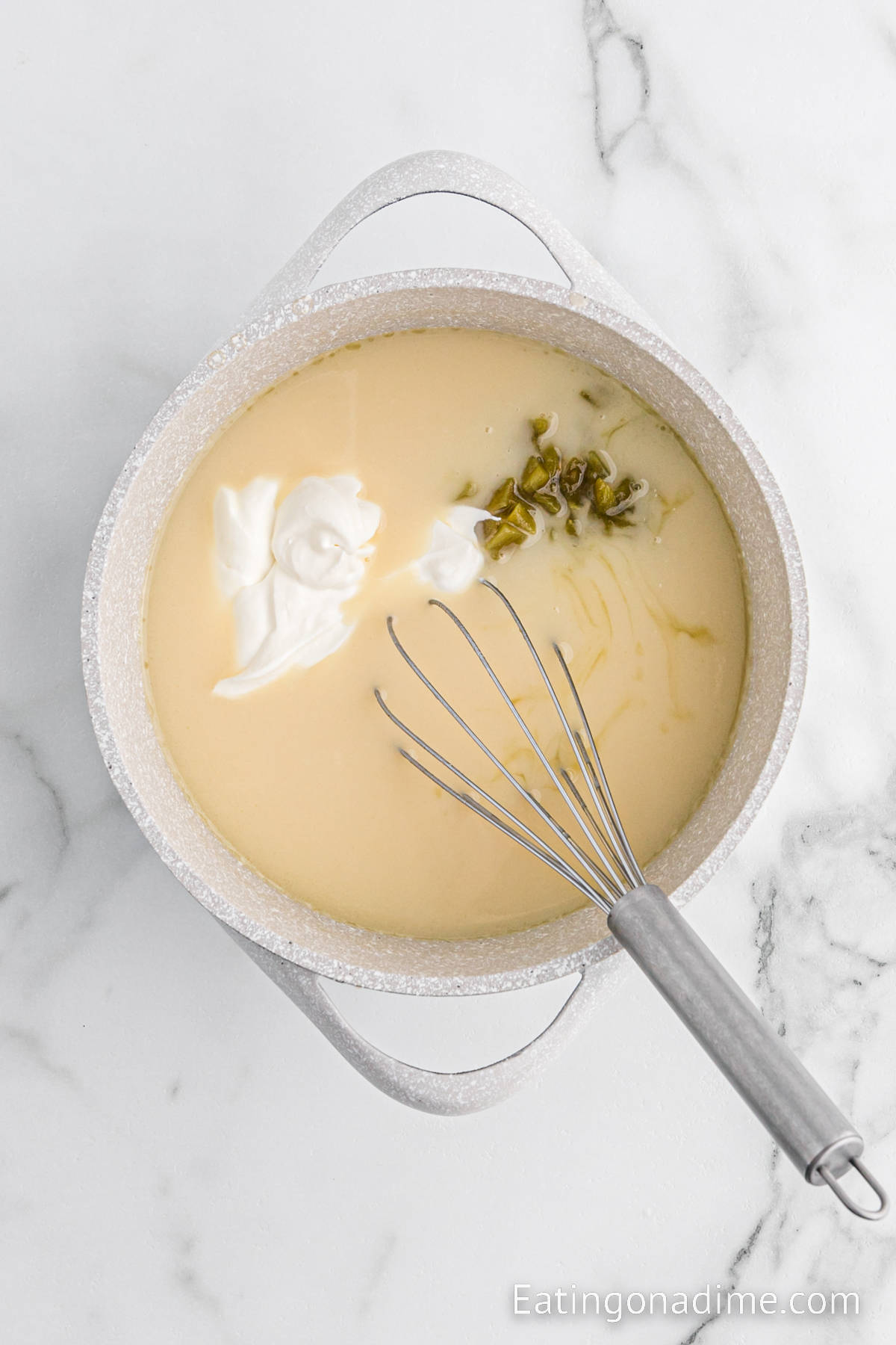 Sour cream, broth and green chiles are added to the butter mixture to make a creamy sauce