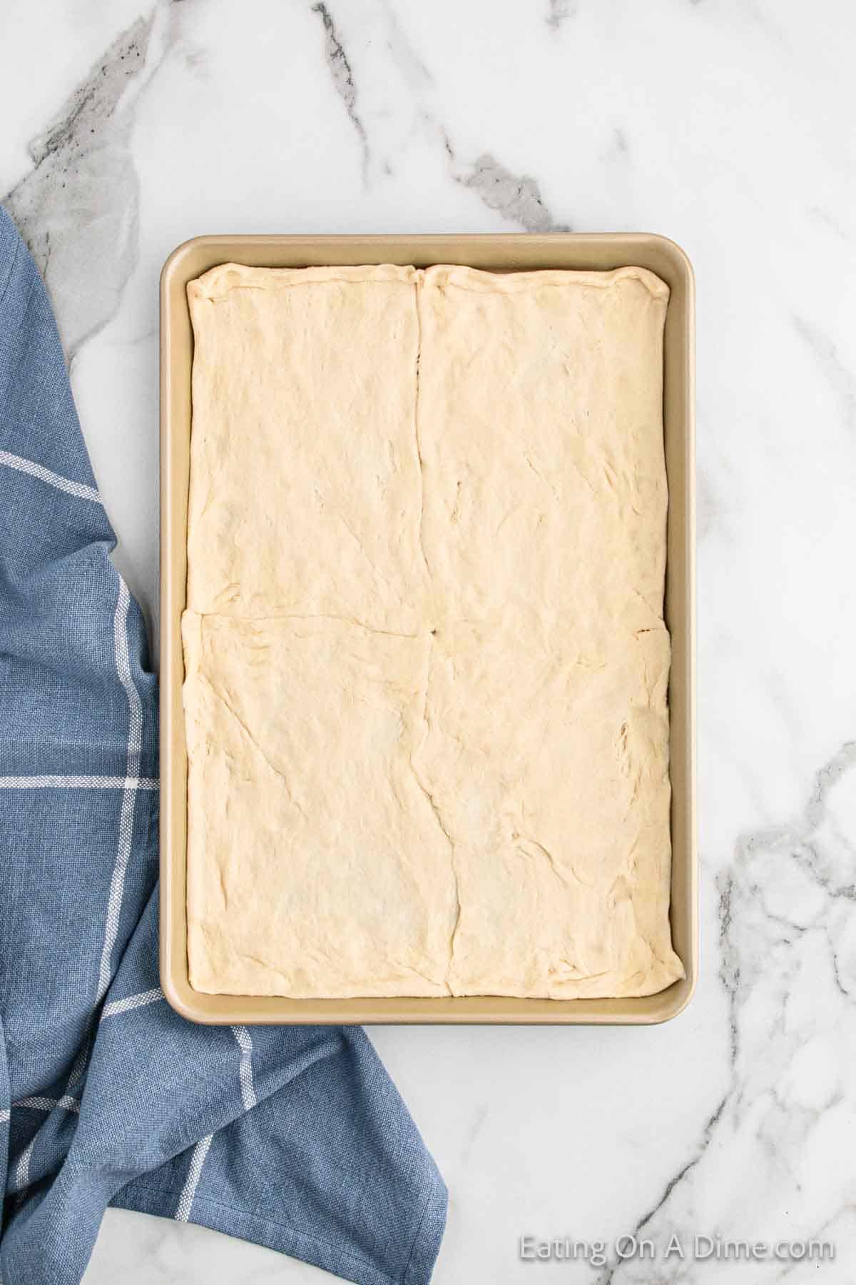 Crescent Roll dough pressed onto baking sheet