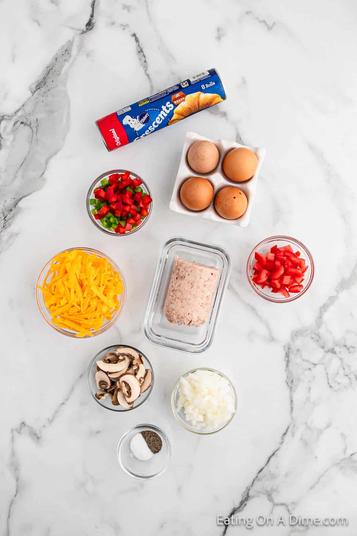 Ingredients for Crescent Roll Breakfast Pizza - Crescent Roll Dough, Breakfast sausage, eggs, salt, pepper, bell peppers, onions, mushrooms, tomatoes, cheese