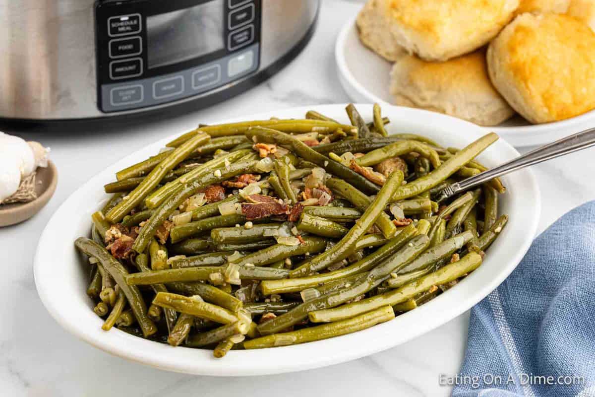 Green Beans on a platter topped with onions and bacon