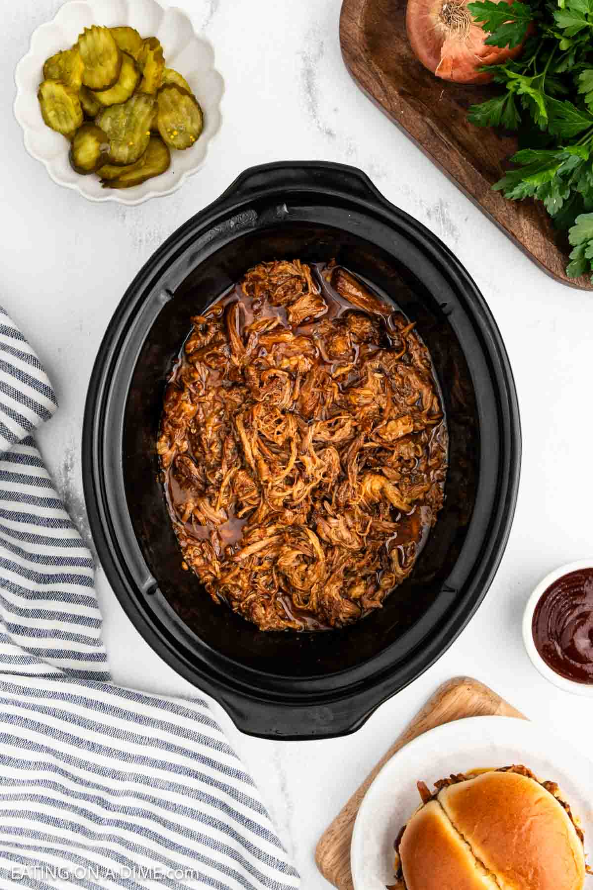 Shredded pork cooked in juices in the crock pot.