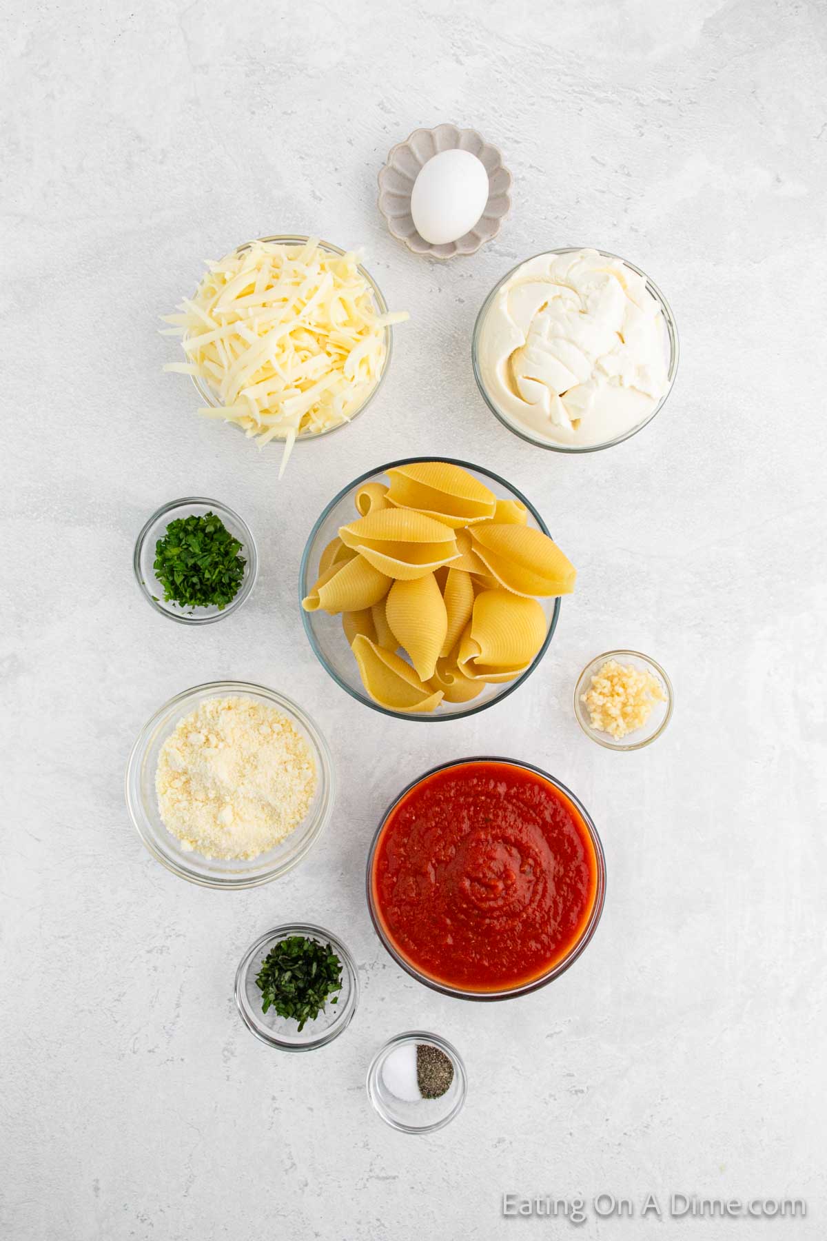 Jumbo Pasta Shells, ricotta cheese, parmesan cheese, egg, minced garlic, parsley, basil, salt, pepper, marinara sauce, mozzarella cheese