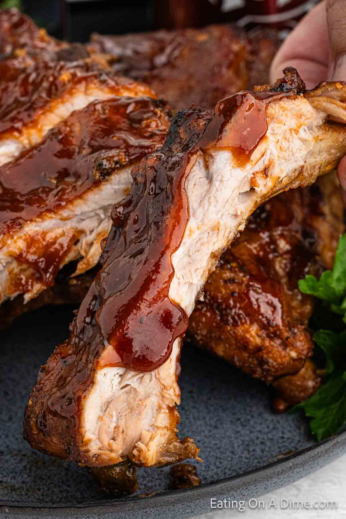 Cooked ribs topped with BBQ Sauce