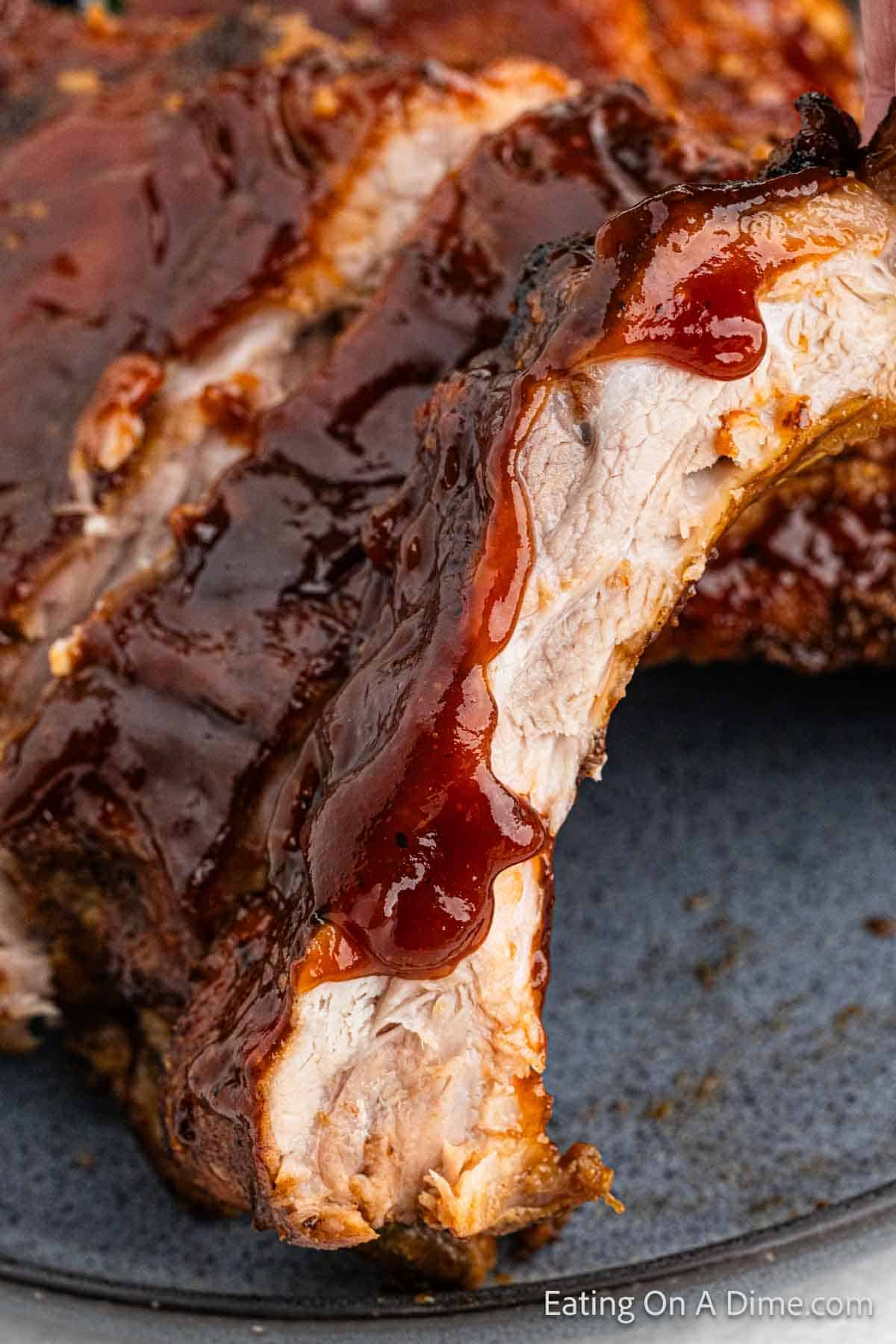 Cooked Ribs topped with BBQ Sauce