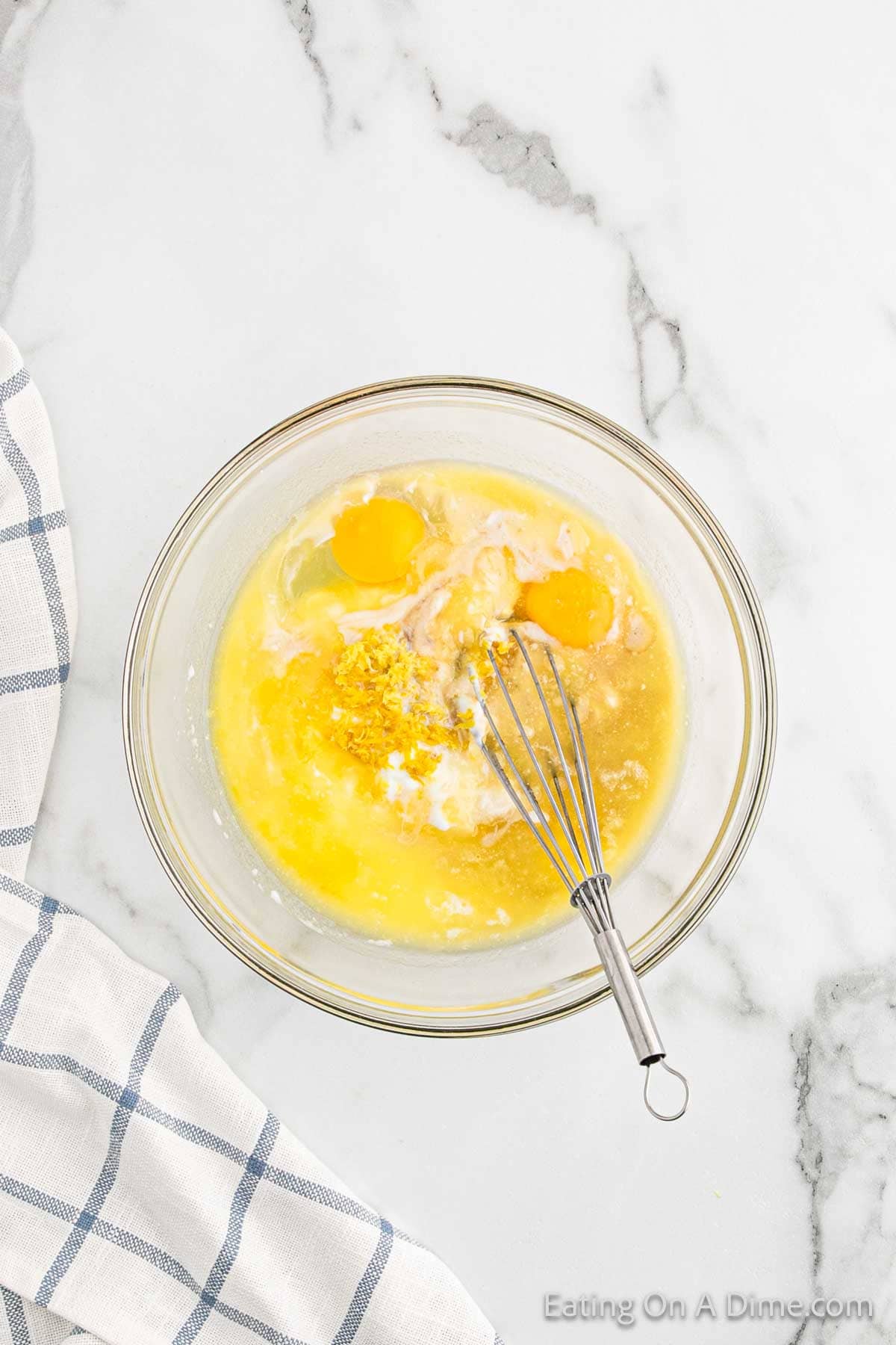 Combine the yogurt, milk, lemon, butter, eggs, and vanilla extract in a bowl with a wooden spoon