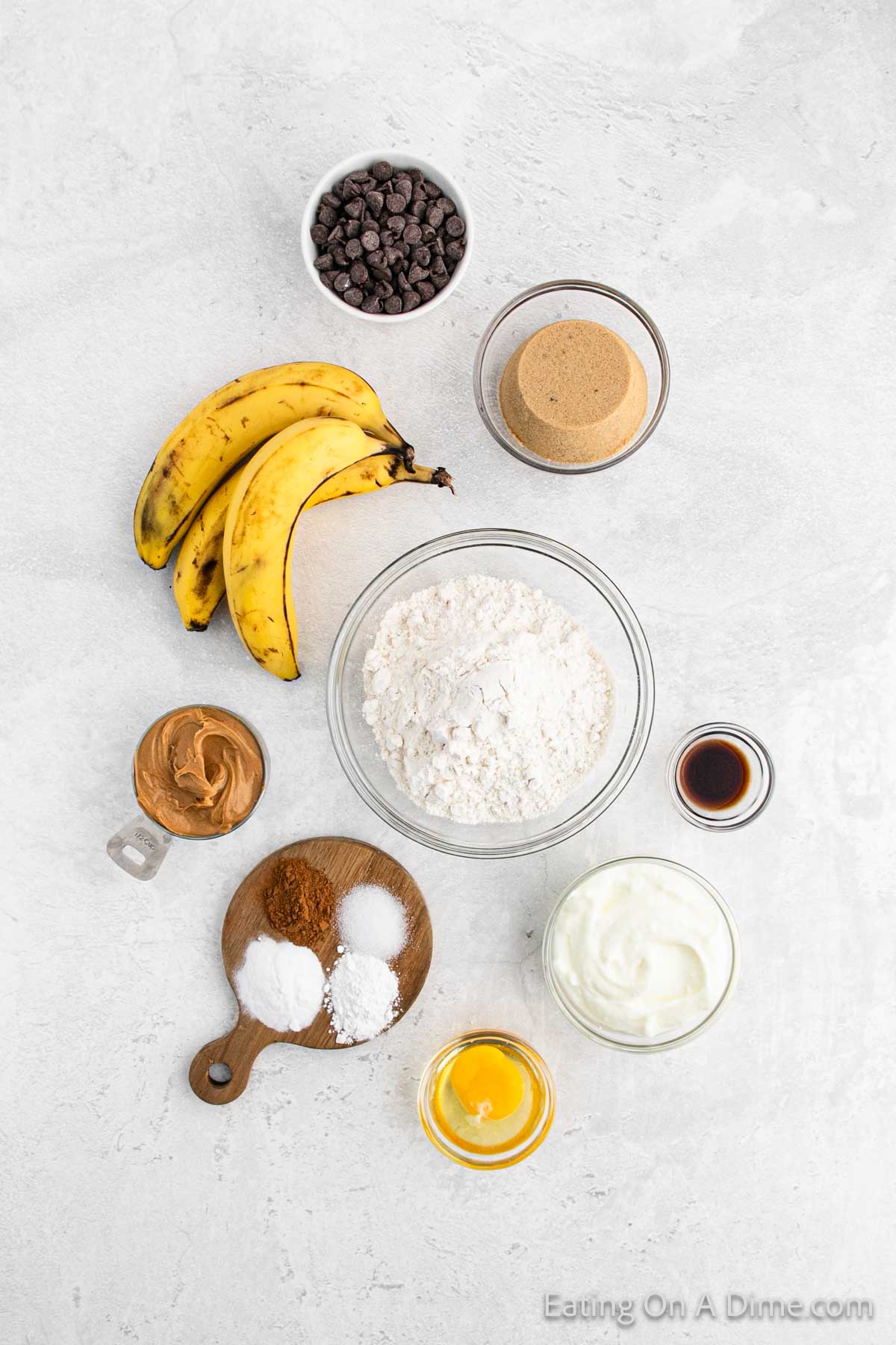 Peanut Butter Banana Muffin Ingredients - Flour, baking powder, baking soda, cinnamon, salt, brown sugar, egg, bananas, peanut butter, yogurt, vanilla, chocolate chips