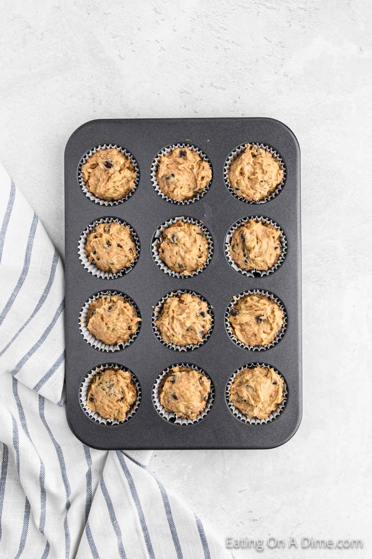 Filling the muffin batter into the muffin tin