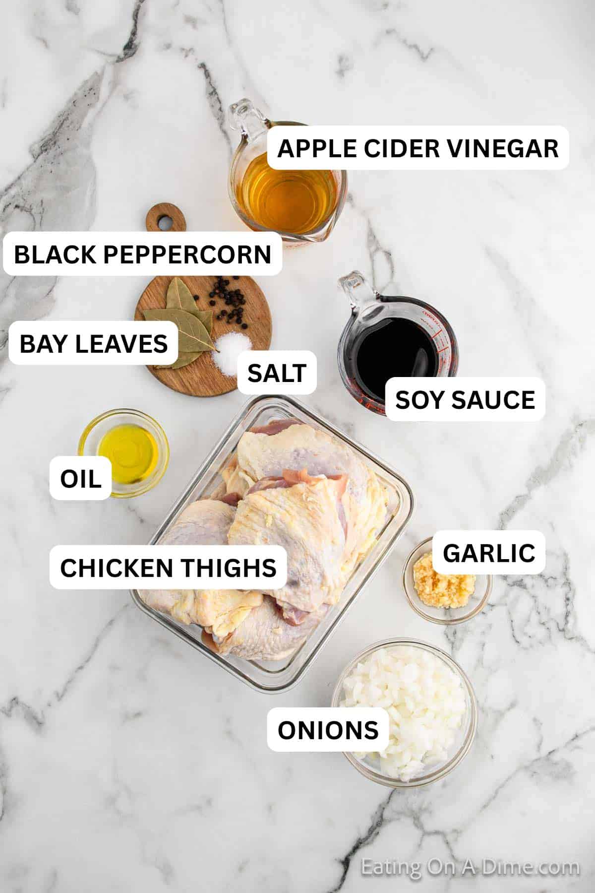 Chicken adobo ingredients needed for this recipe includes olive oil, chicken thighs, garlic, onion, bay leaves, black peppercorns, salt, apple cider vinegar, soy sauce.