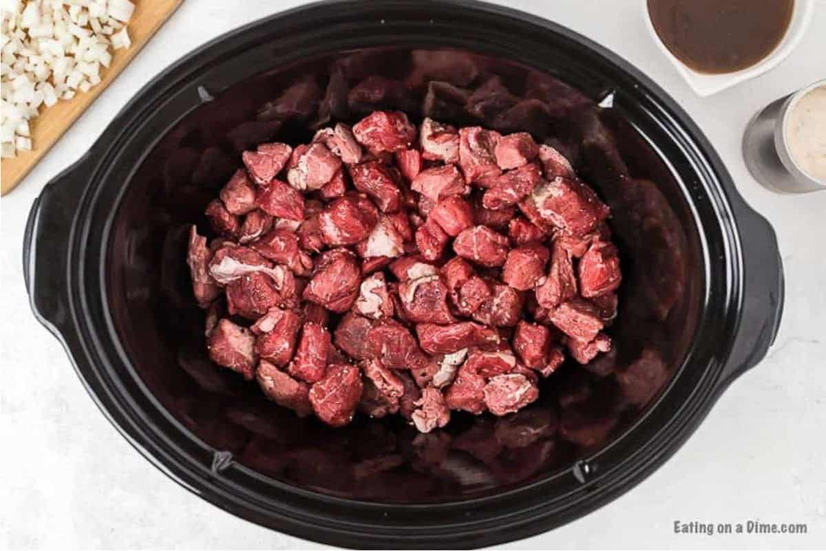Placing the stew meat in the slow cooker