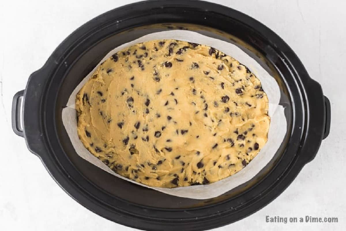 Pressing the cookie dough in the slow cooker 