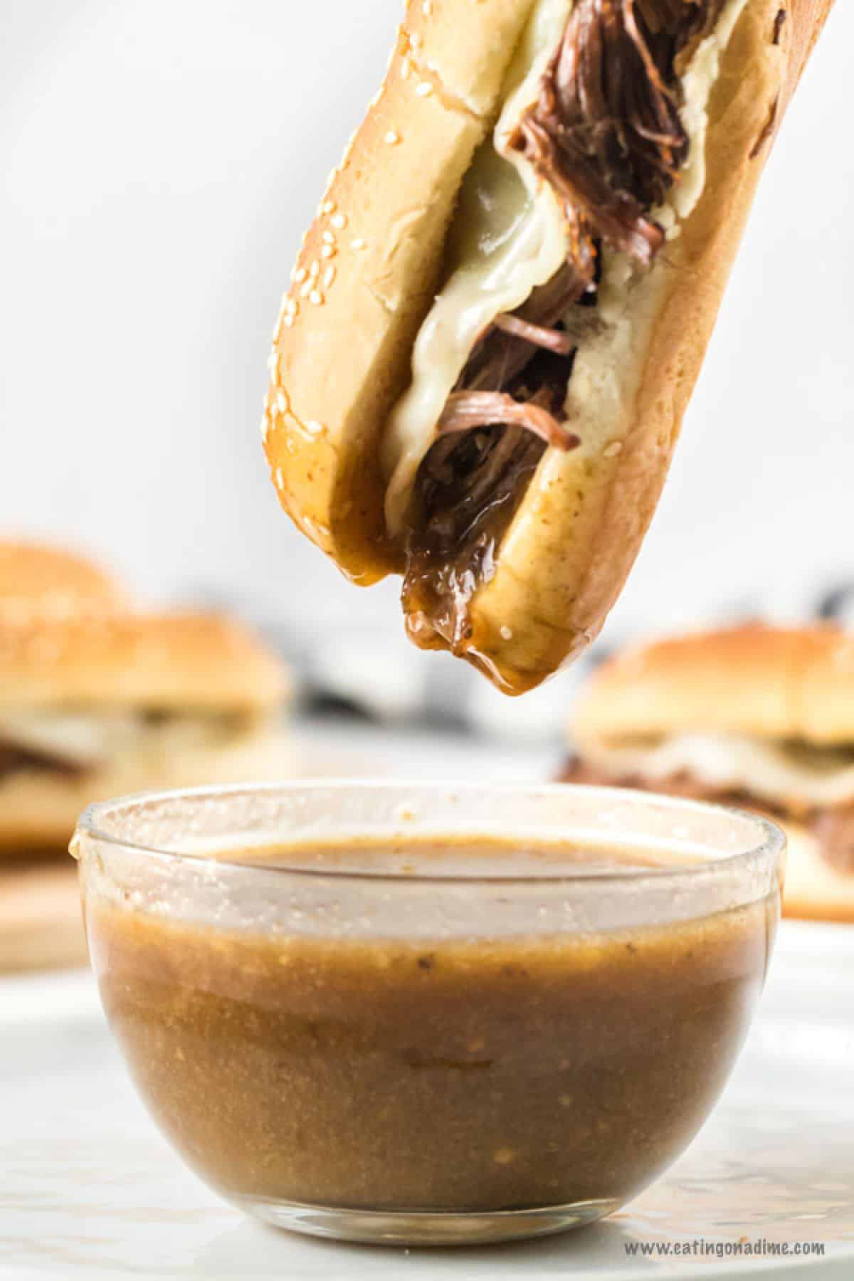 Dipping the french dip sandwiches in the gravy
