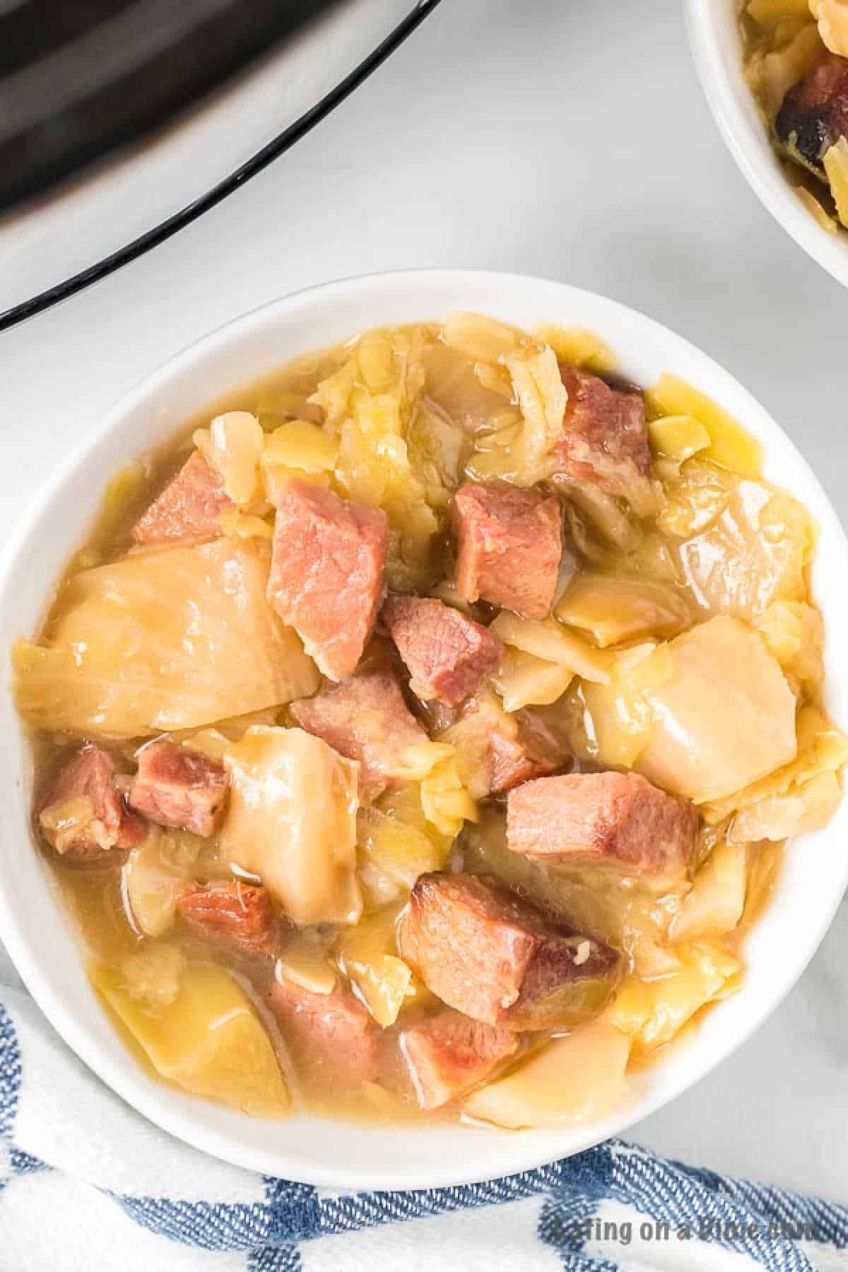 Cabbage and Ham soup in a white bowl