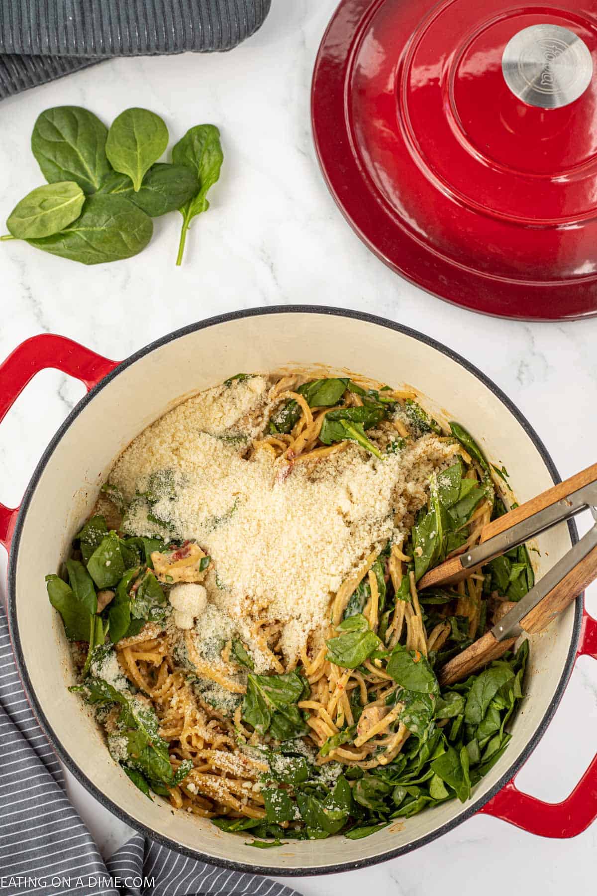 Fresh spinach topped with parmesan cheese mixed with the cooked chicken and spaghetti noodles