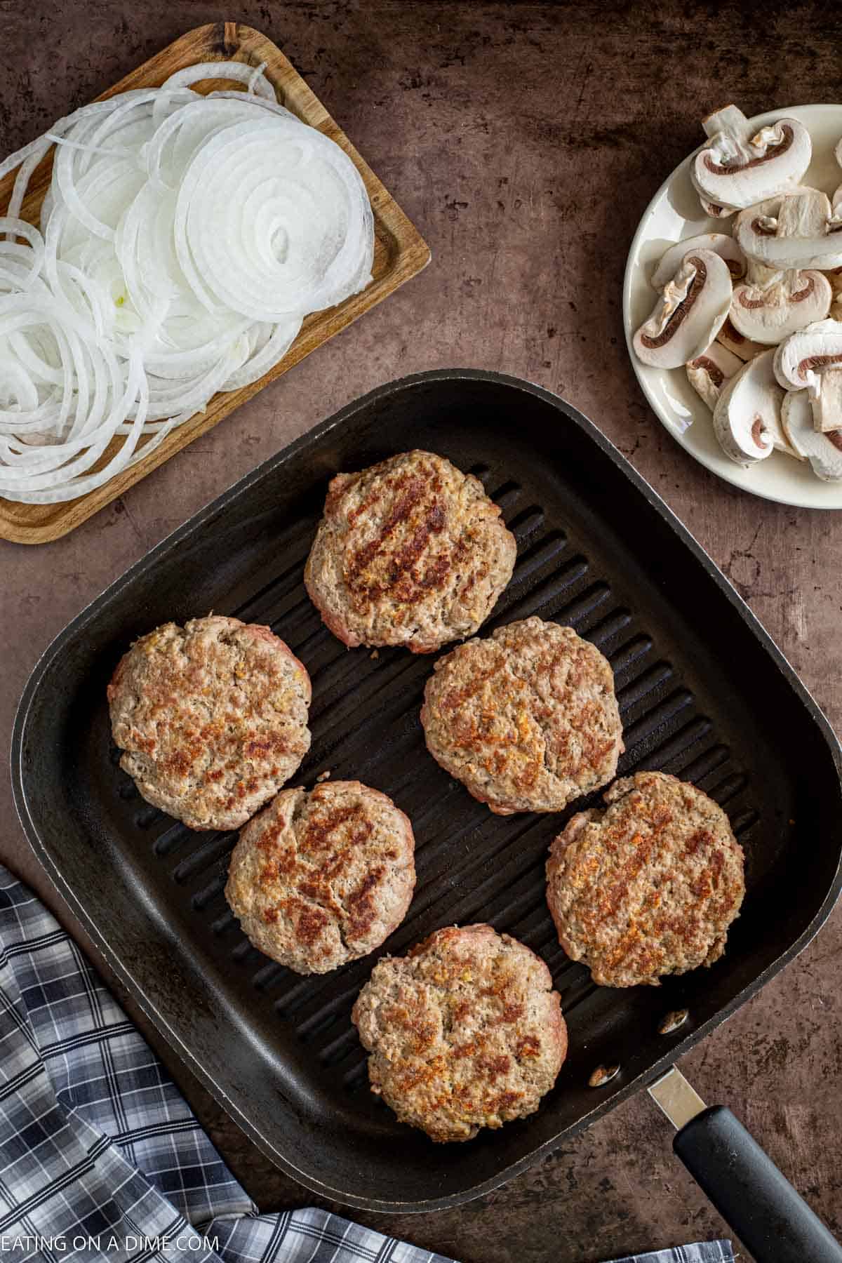 Cooking the beef patties in a skillet