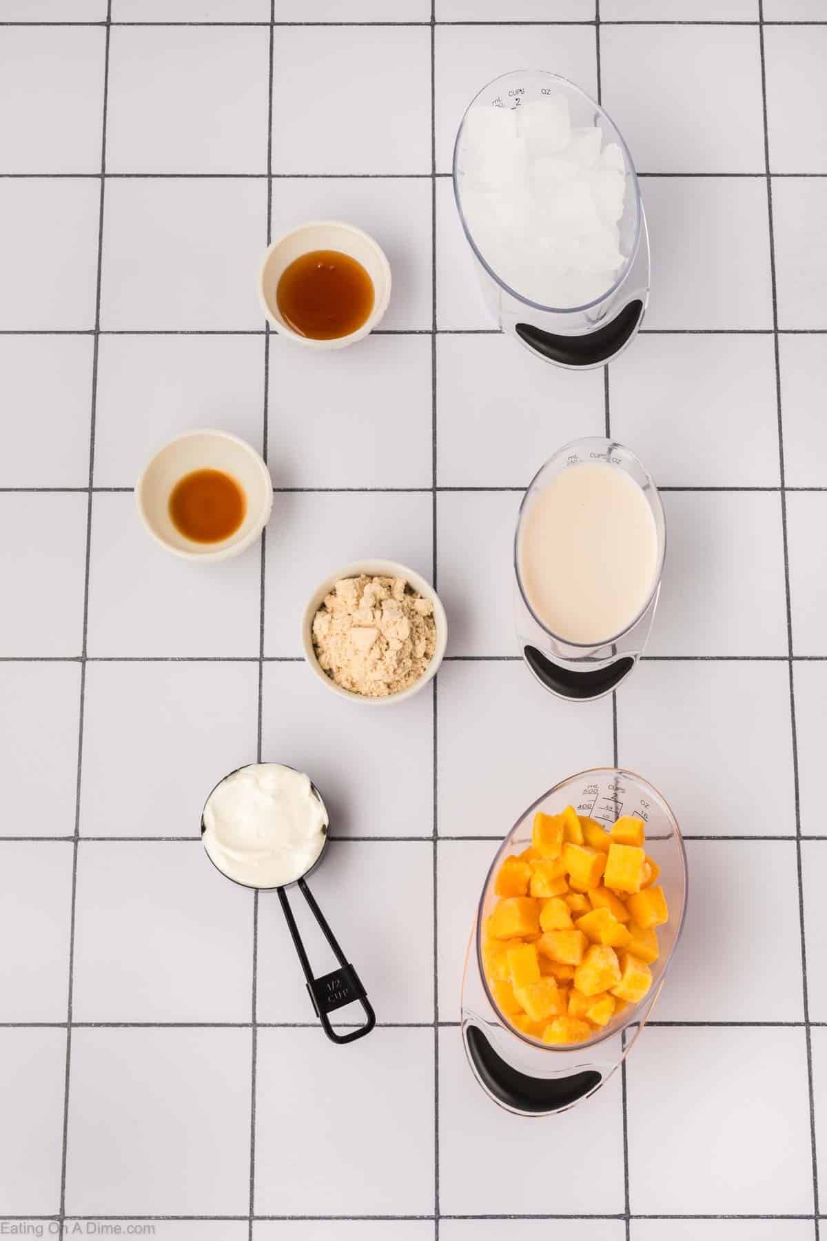 Mango Protein Smoothie Ingredients - frozen mango chunks, protein powder, milk, Greek yogurt, honey, vanilla extract, ice cubes