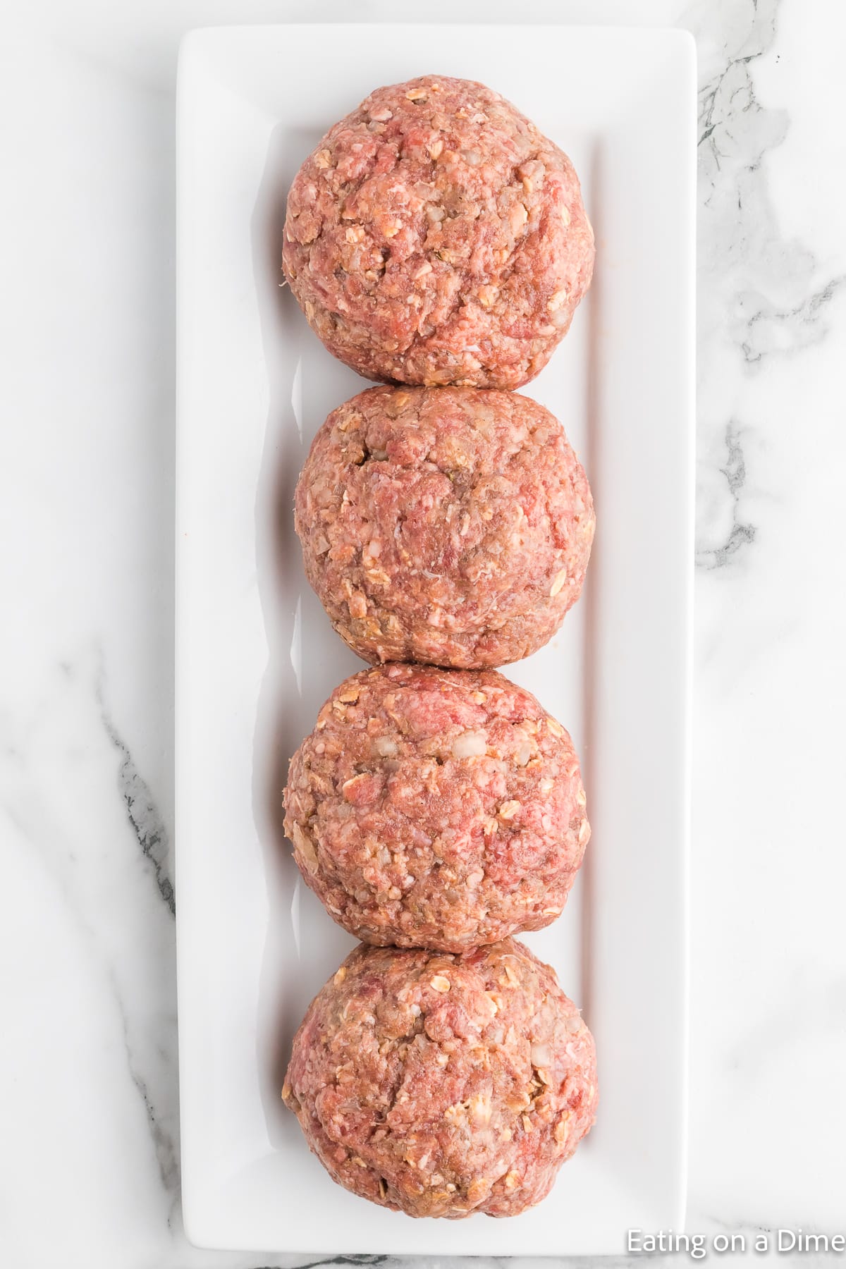 Forming ground beef mixture into patties and placing on a platter