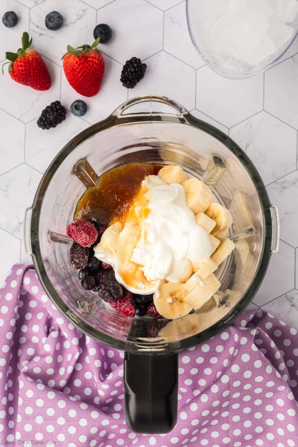 Honey, frozen berries, slice bananas, yogurt in a blender