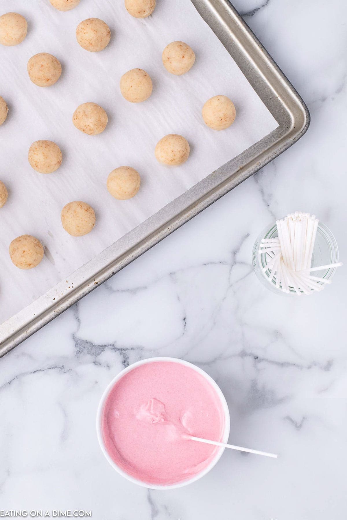 Melting pink candy melts and dipping the cake stick into the melted candy