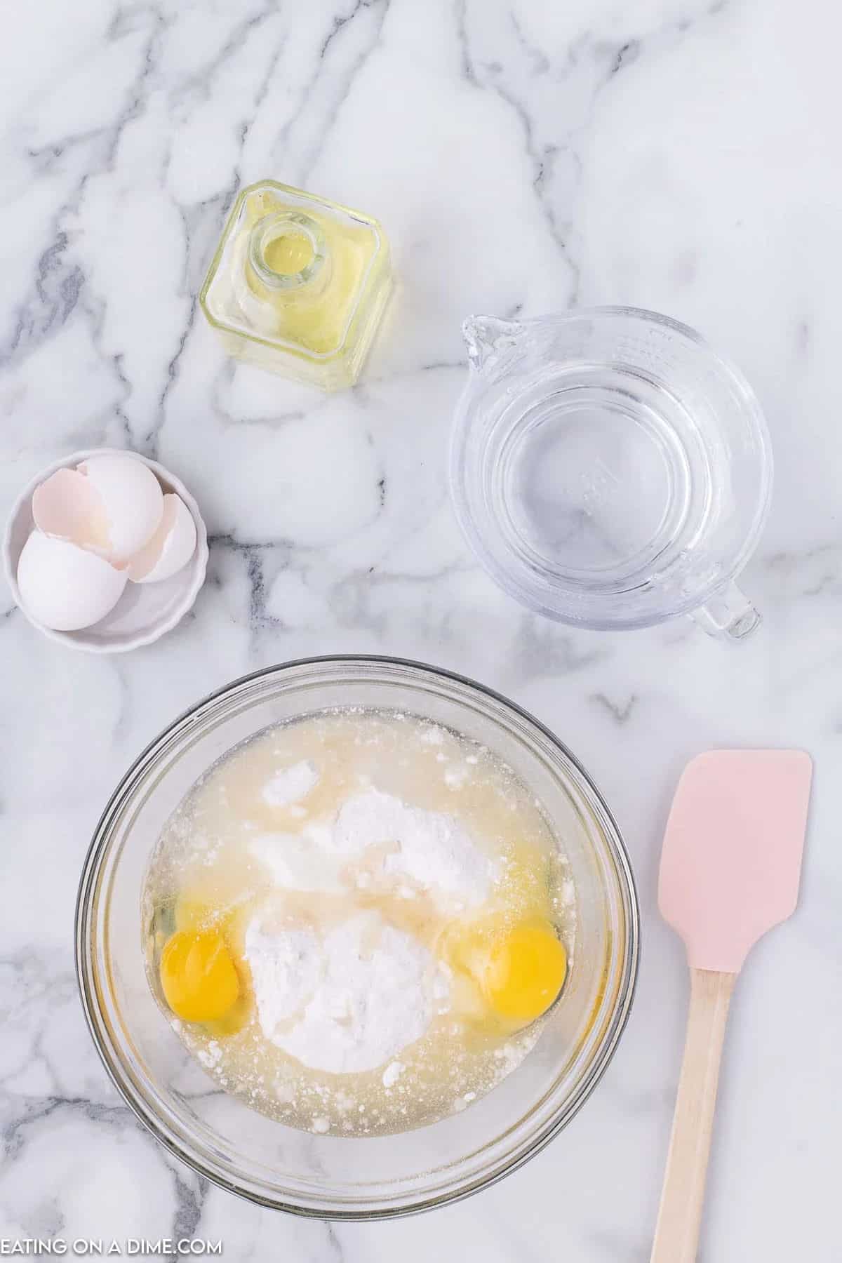 Combining cake mix ingredients in a bowl