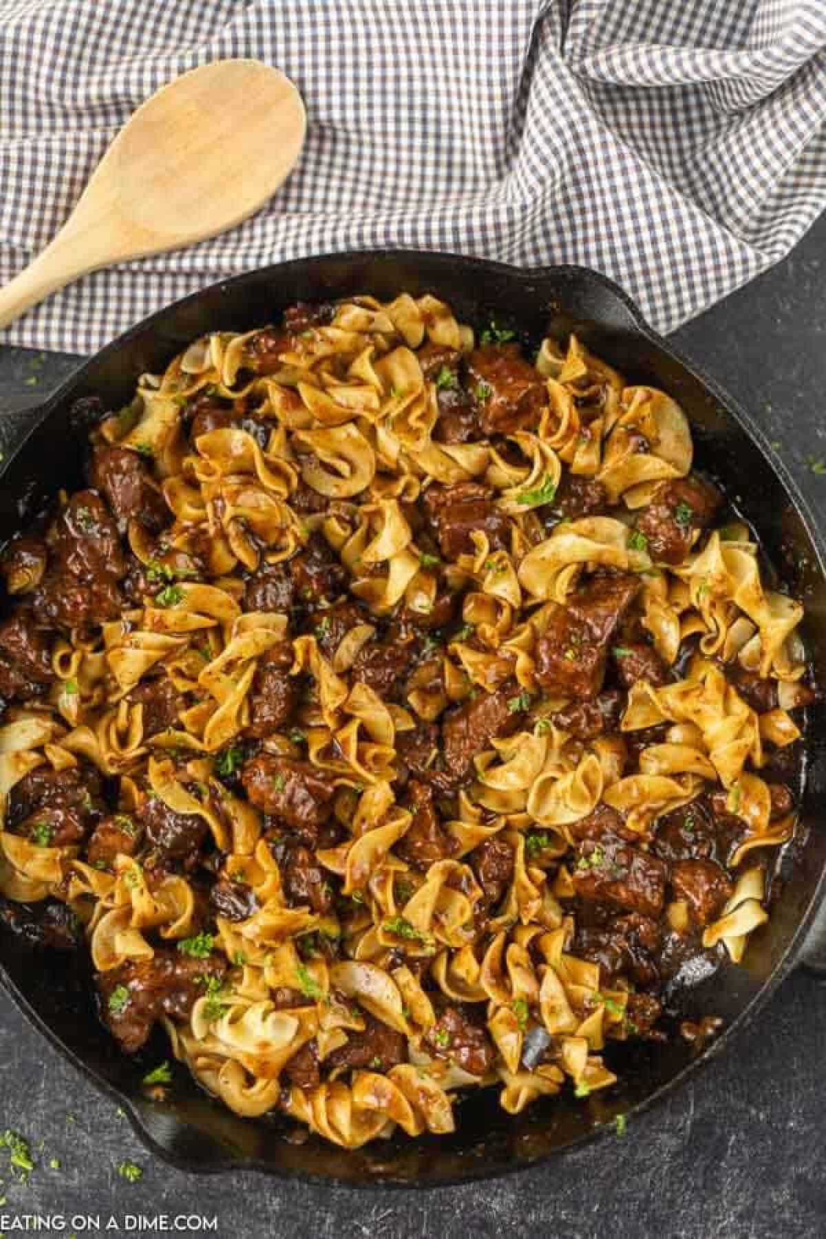 Close up image of Beef and Noodles in a iron skillet. 