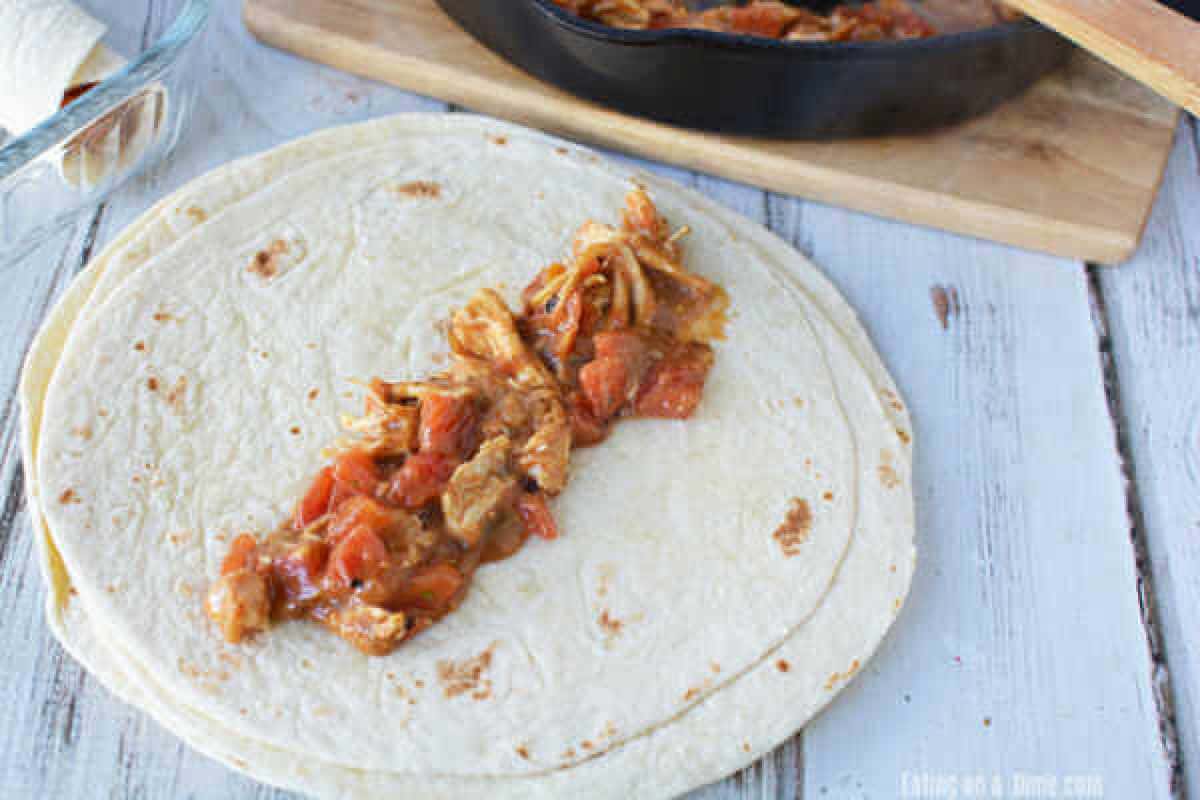 The chicken mixture placed on the center of a flour tortilla.  