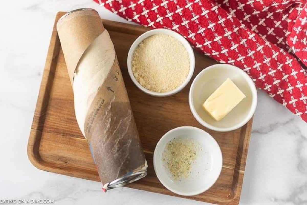 Ingredients to make this crazy bread recipe- pizza crust, garlic salt, unsalted butter, parmesan cheese