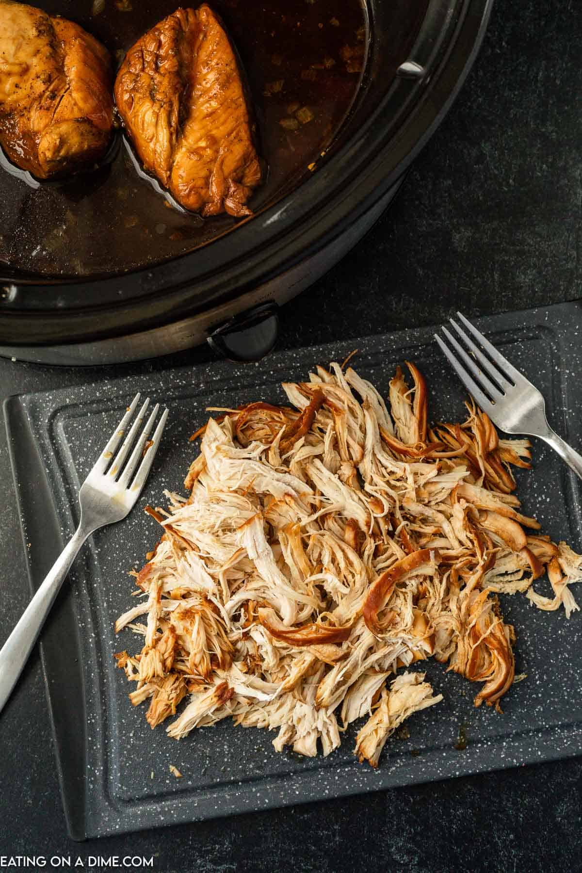 Shredded chicken on a cutting board