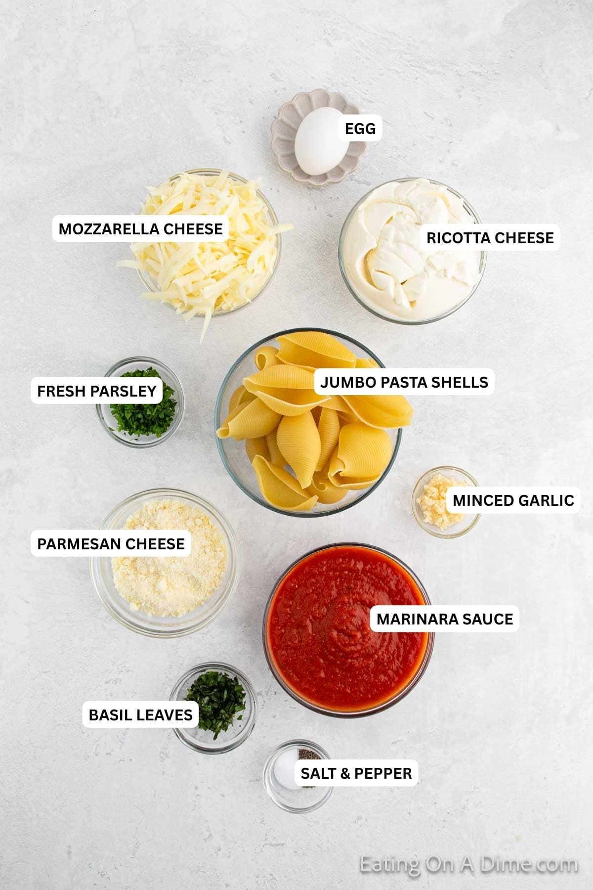 Ingredients for recipe: salt, pepper, basil leaves, marinara sauce, parmesan cheese, minced garlic, jumbo pasta shells, parsley, ricotta cheese, mozzarella cheese and egg.