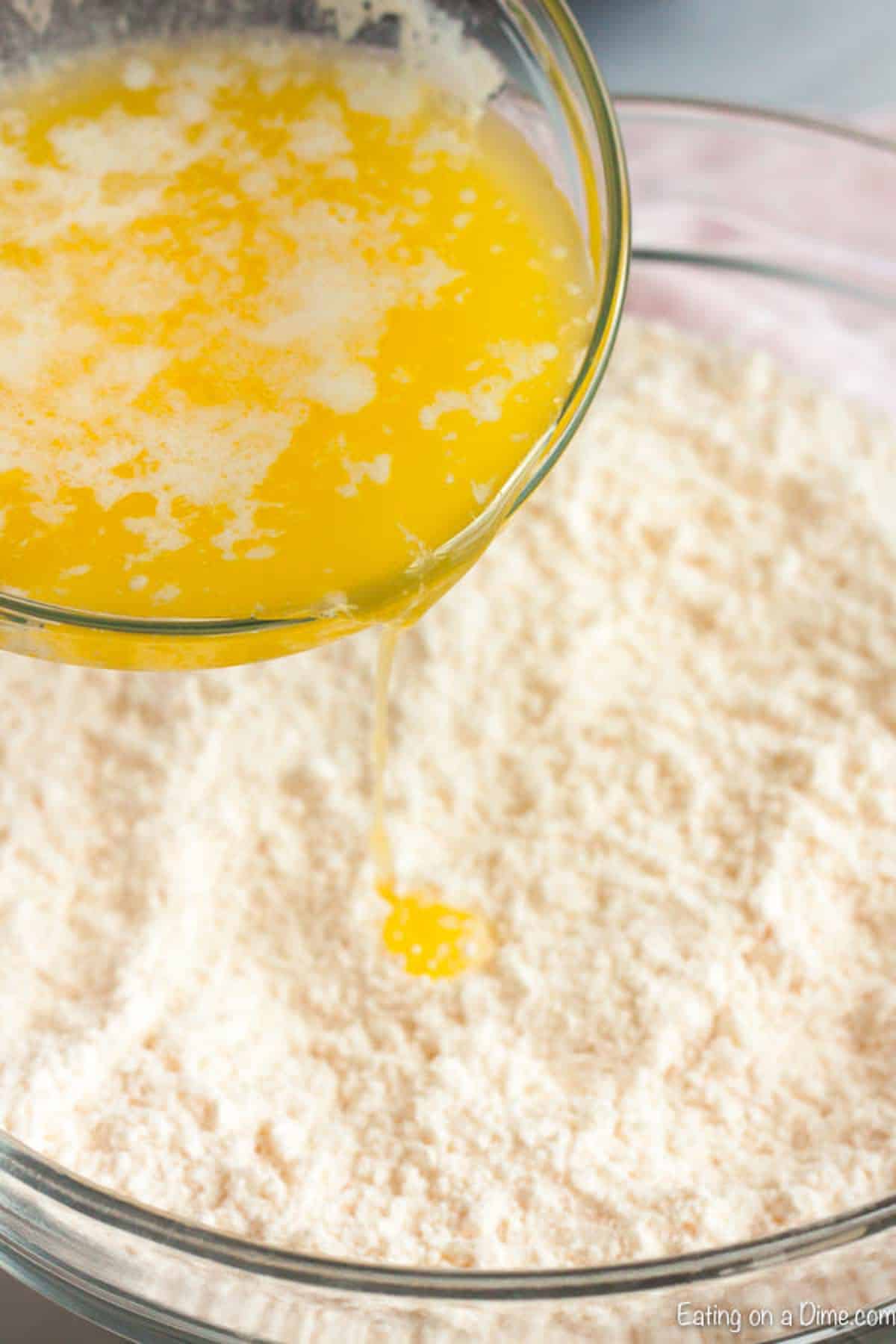 Pouring melted butter over cake mix 