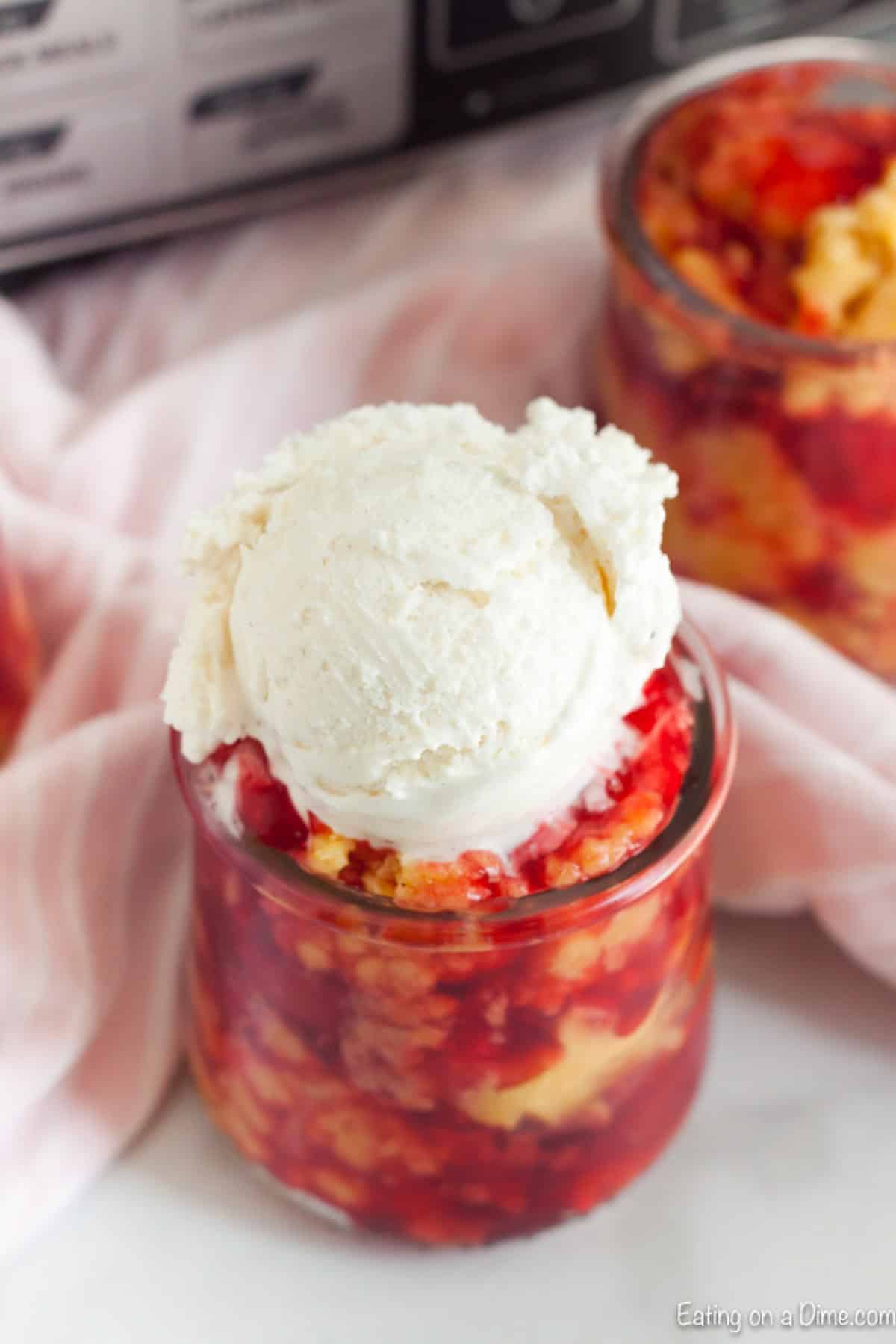 Cherry Dump Cake in a jar topped with vanilla ice cream