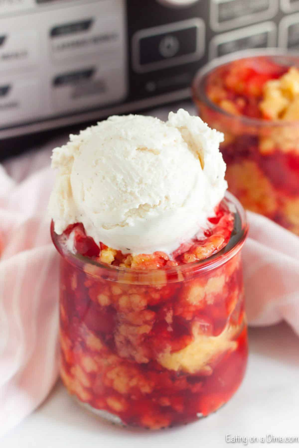 Cherry Dump Cake in a jar topped with vanilla ice cream