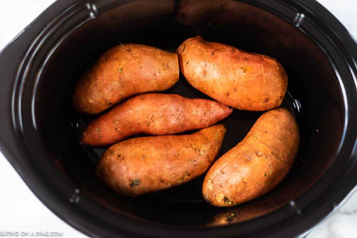 Placing sweet potatoes in slow cooker