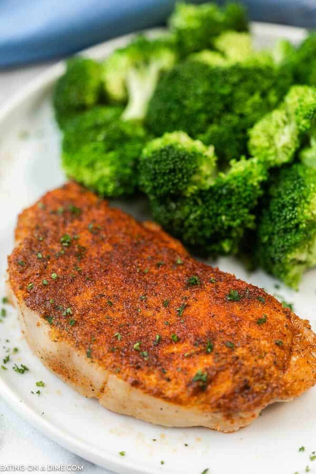 pork chop with broccoli on white plate