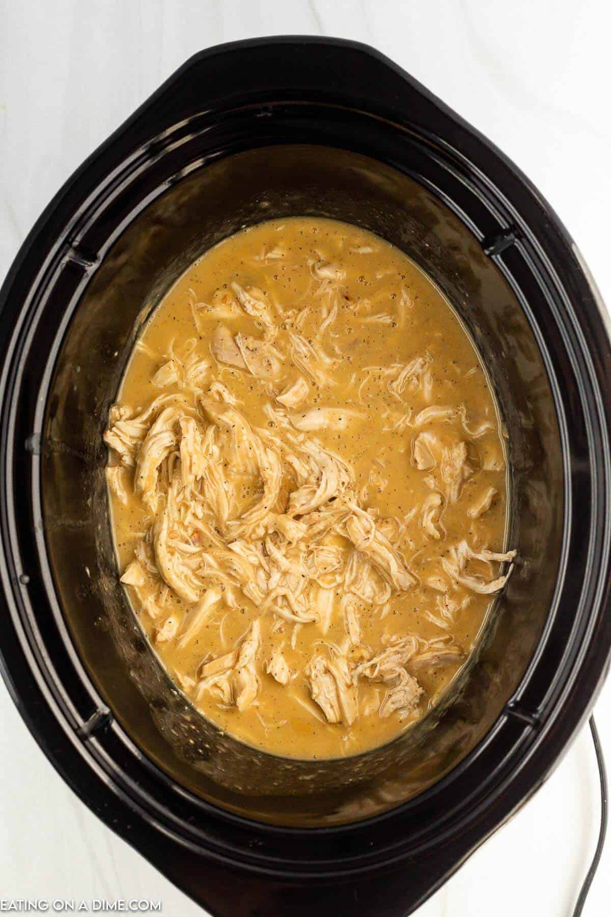 Stirring the shredded chicken in the slow cooker