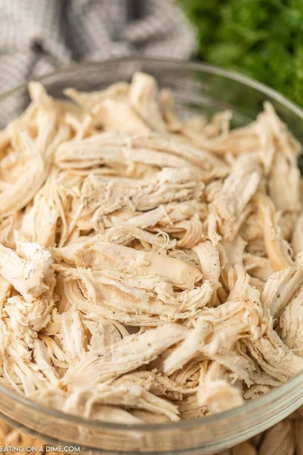 shredded chicken in a glass bowl