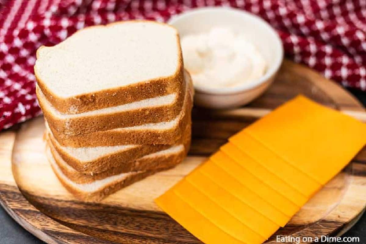 Grilled Cheese Sandwich Ingredients - Slice of White Bread, slice cheeses, and mayonnaise