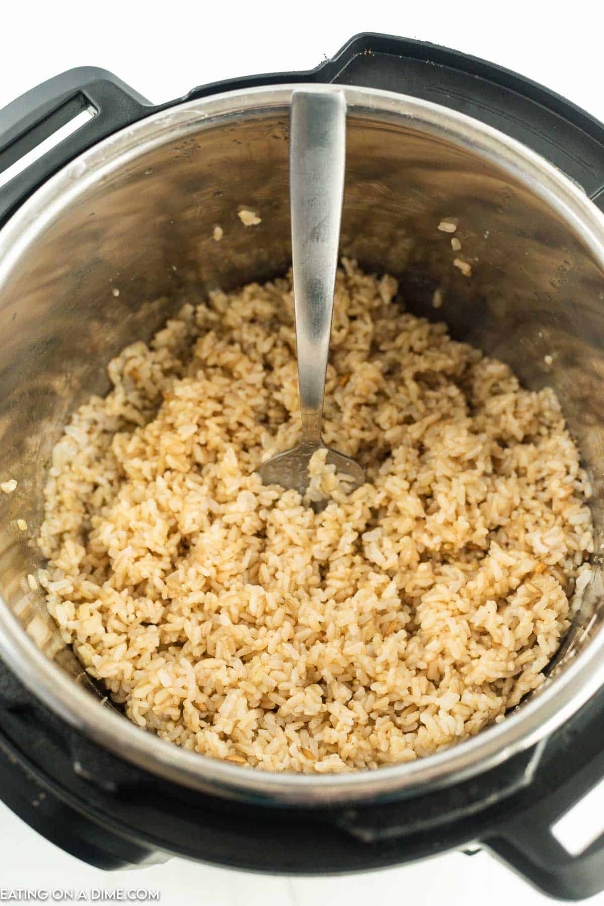 Cooked brown rice in the instant pot and fluffing with fork