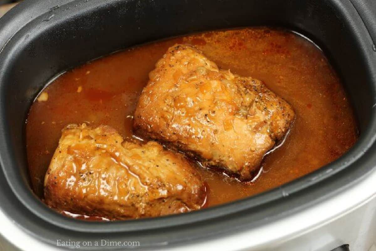 Cooked pork in the slow cooker with the juices