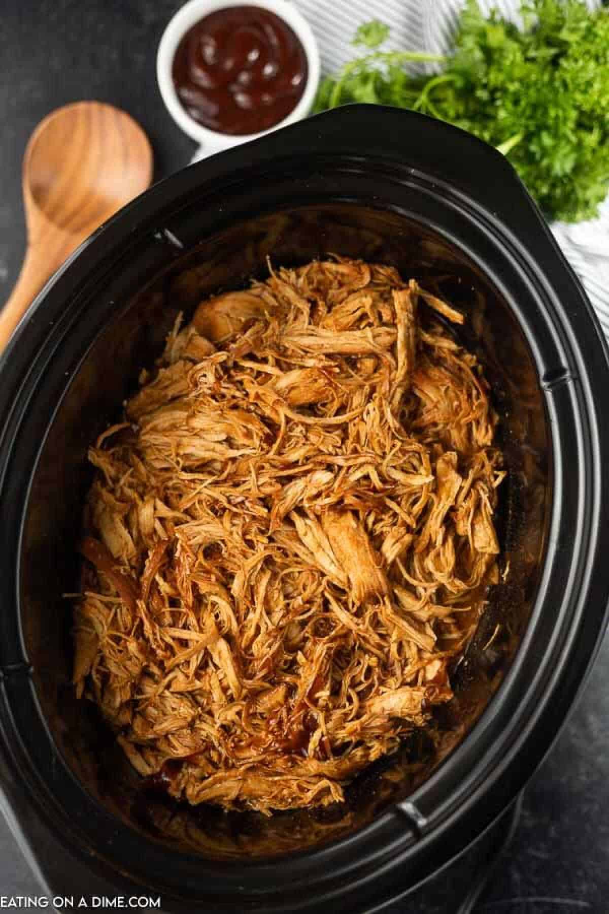 Root Beer BBQ Shredded Chicken in a Black Crock Pot 