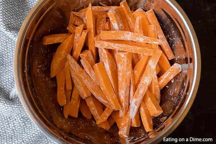 Slice sweet potato topped with cornstarch in a bowl
