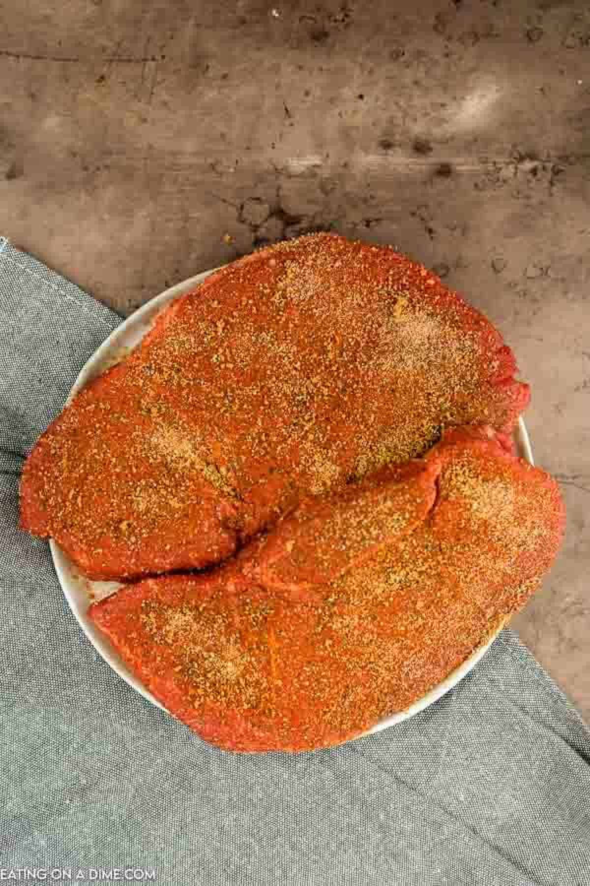 Texas Roadhouse Steak coated in seasoning. 