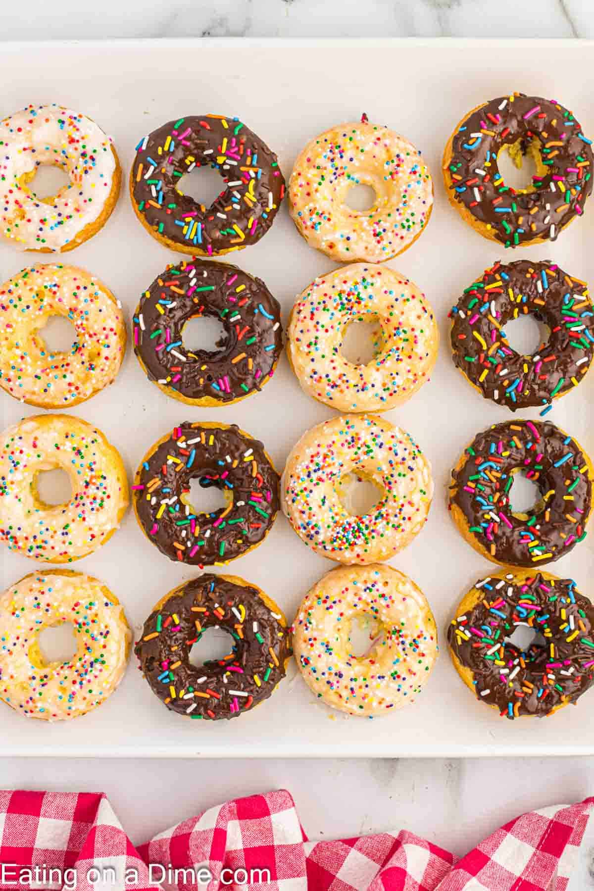 Chocolate and Vanilla Glazed Donuts with sprinkles on a platter