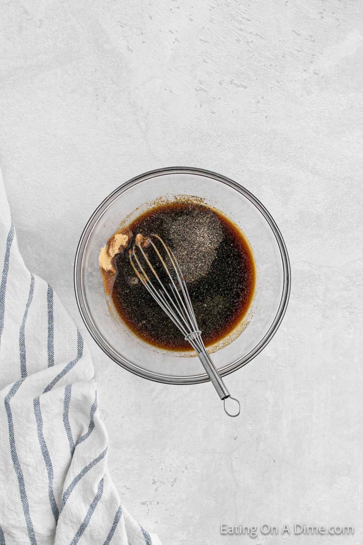 Whisking the marinade ingredients in a bowl