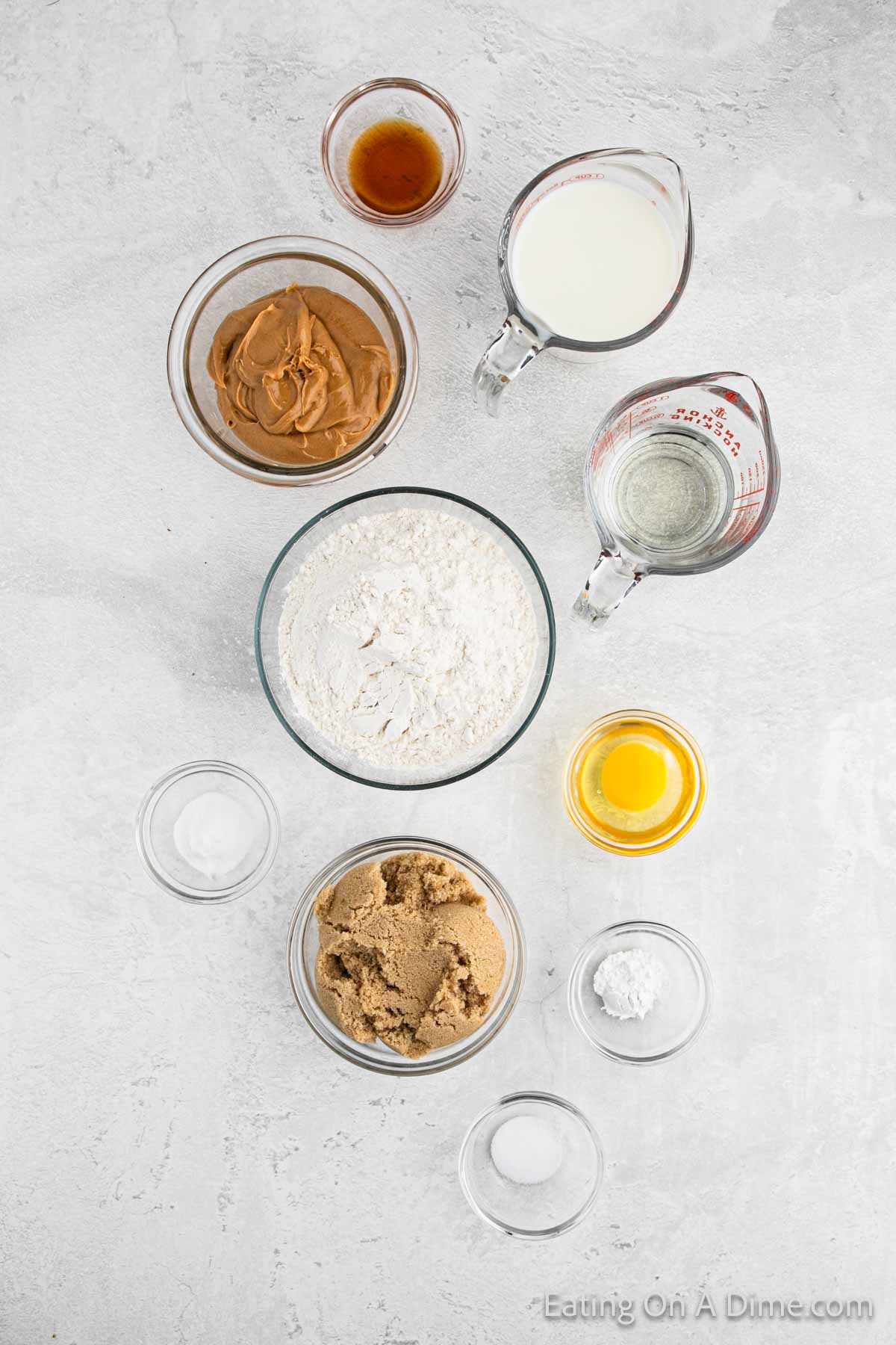 Peanut butter muffin ingredients - flour, baking powder, baking soda, salt, brown sugar, egg, peanut butter, oil, milk, vanilla extract