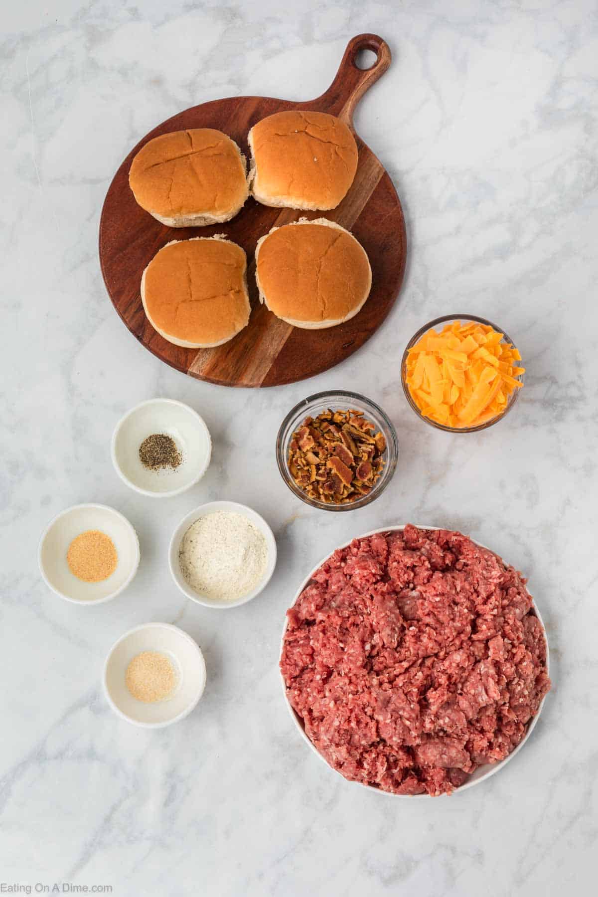 Ingredients - ground beef, ranch dressing mix, garlic powder, onion powder, black pepper, bacon, cheese, hamburger buns