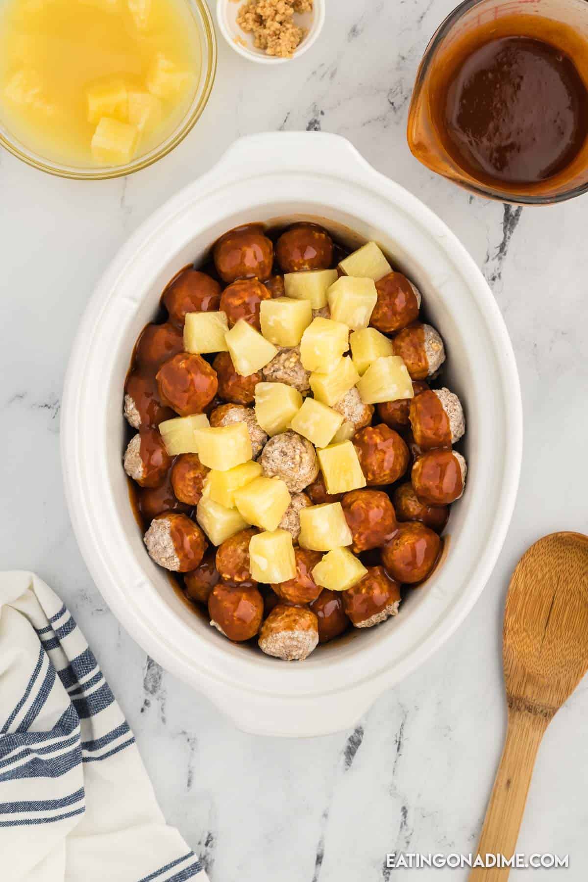 Meatballs, sauce, and pineapple chunks in the slow cooker